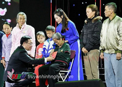 Chủ tịch Quốc hội Vương Đình Huệ trao quà Tết cho chị Nguyễn Thị Đông - người không may gặp tai nạn thương tâm trở thành tàn phế.
