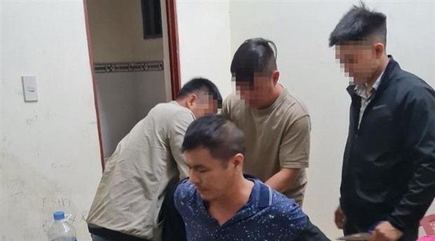 Yang Zhong Wu bị công an bắt giữ. (Ảnh: TTXVN phát)