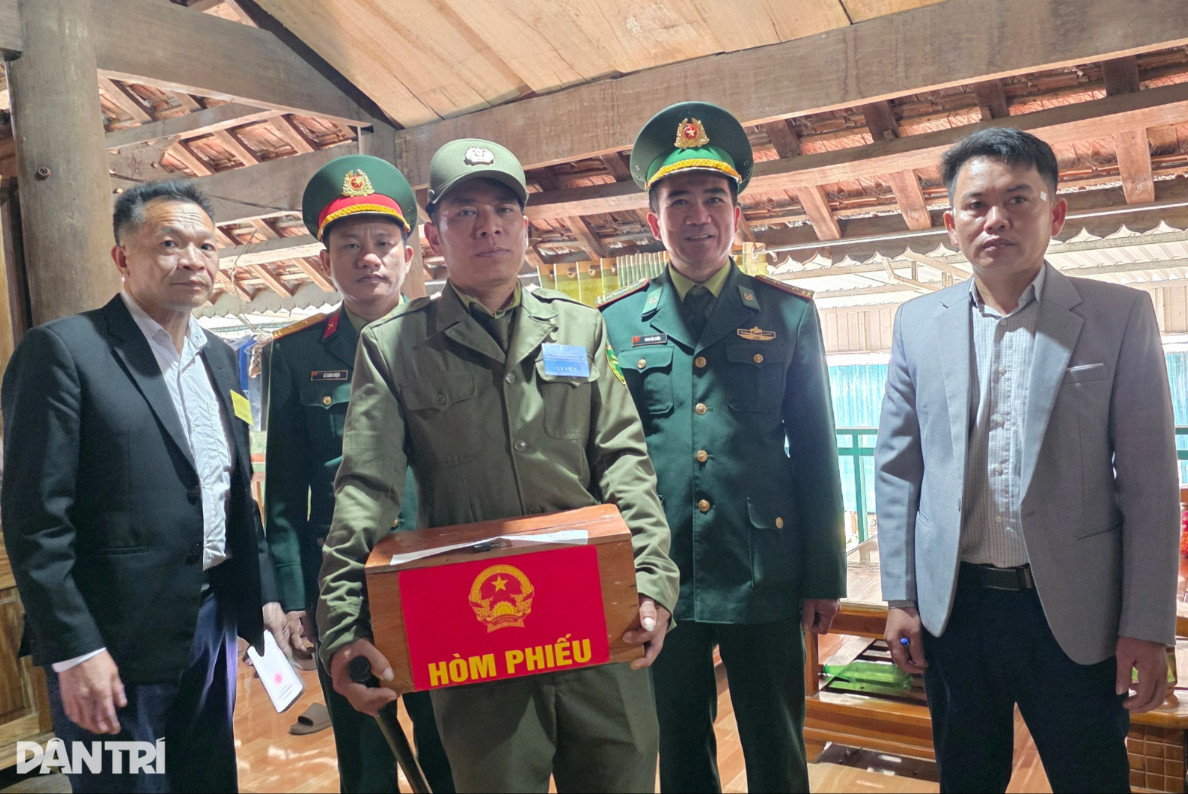 Cán bộ tổ bầu cử mang thùng phiếu phụ đến tận nhà hai cử tri cao tuổi ở bản Xằng (Ảnh: Nguyễn Phê).