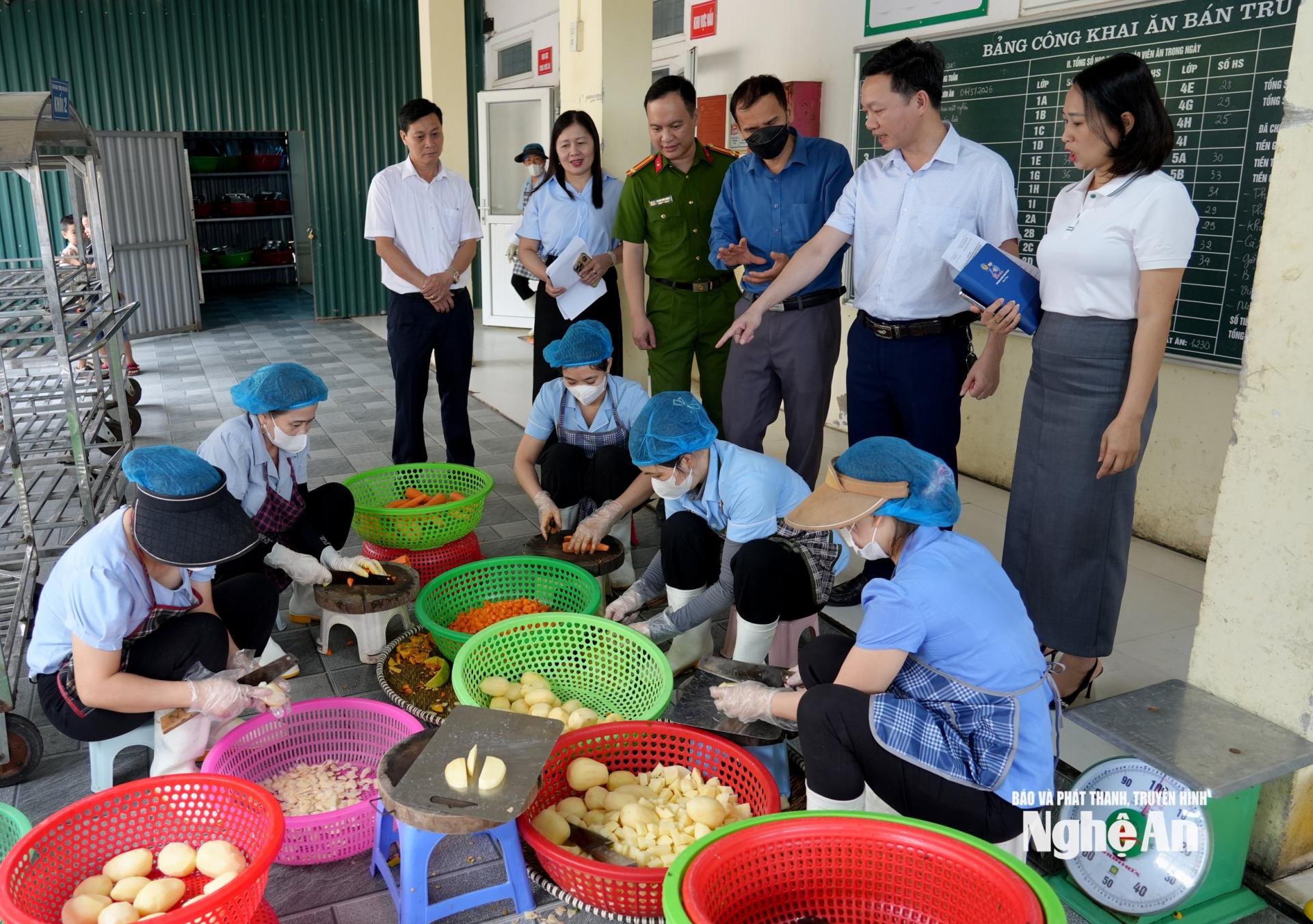 Đoàn kiểm tra thực tế khu vực chế biến bếp ăn tập thể Trường Tiểu học Nghi Kim. Ảnh: Thành Chung