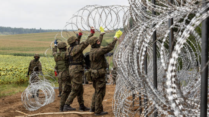 Binh sĩ quân đội Ba Lan dựng hàng rào bằng dây thép ở biên giới Belarus. (Ảnh: Getty)