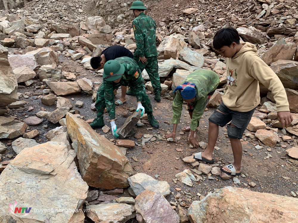 Cán bộ chiến sỹ Đồn Biên phòng Mường Ải (BĐBP Nghệ An) phối hợp cùng nhân dân địa phương khắc phục tình trạng đá sạt lở gây ách tắc giao thông, mất an toàn trên tuyến đường qua địa bàn 