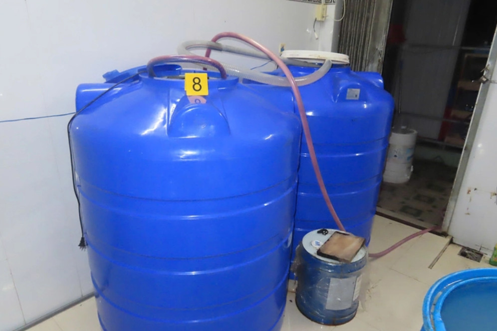 Tang vật tại hiện trường sản xuất hàng giả nước mắm và bột giặt giả của bị can Nguyễn Đức Minh Tâm - Ảnh: TIẾN VĂN