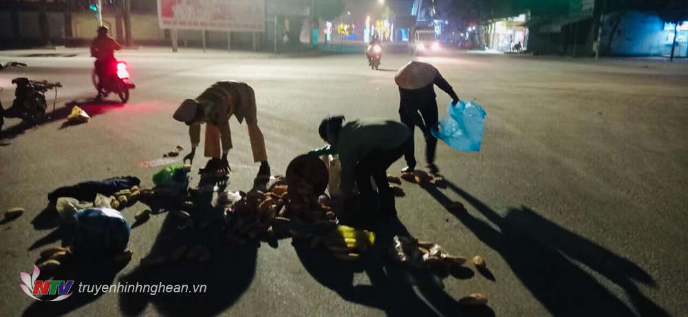Hình ảnh lực lượng CSGT Công an huyện Đô Lương giúp đỡ người dân thu gom bánh mì trong đêm.