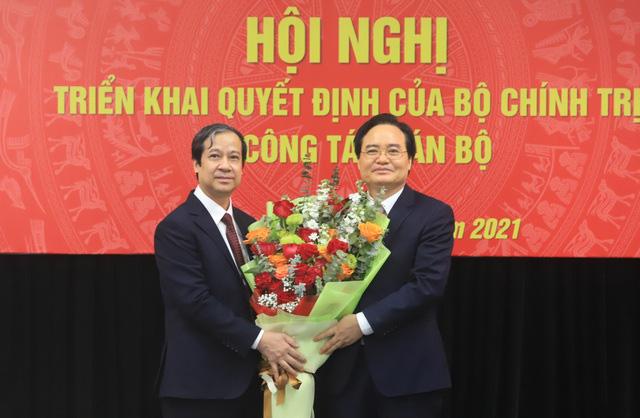 Bộ trưởng Bộ GD&ĐT Nguyễn Kim Sơn tặng hoa chúc mừng tân Phó Ban Tuyên giáo Trung ương Phùng Xuân Nhạ.