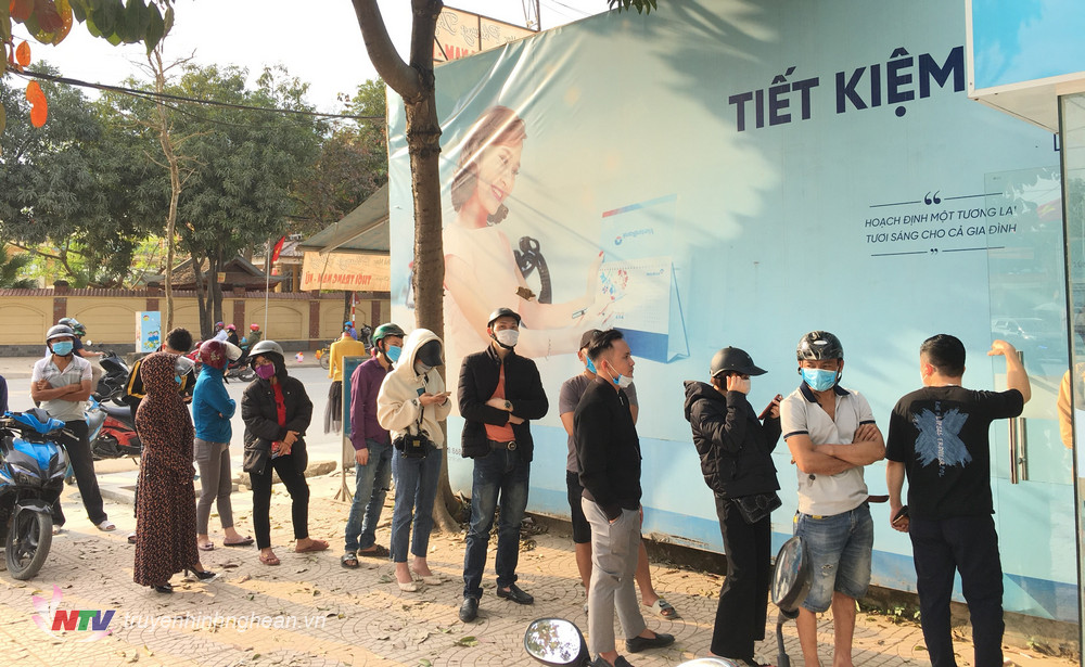 Người dân xếp hàng dài chờ rút tiền tại điểm ATM trên địa bàn huyện Đô Lương.